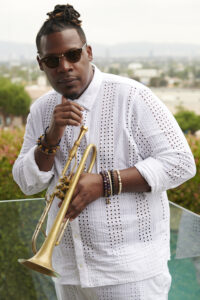 Keyon Harrold ‘FOREVERLAND’ holding trumpet outside