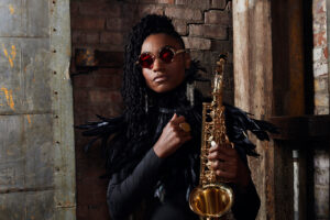Lakecia Benjamin holding a saxophone