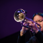 Skylar Tang close up playing trumpet