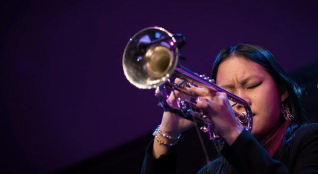 Skylar Tang close up playing trumpet