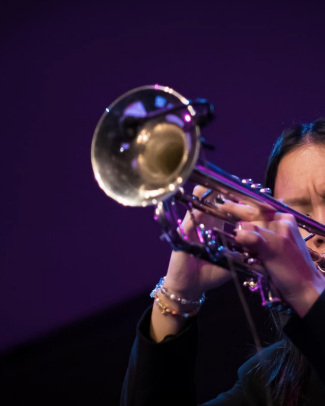 Skylar Tang close up playing trumpet