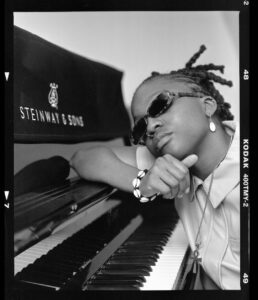 Sequoia “REDWOOD” Snyder black and white photo leaning on piano
